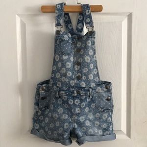 Denim romper, with a white flower print.